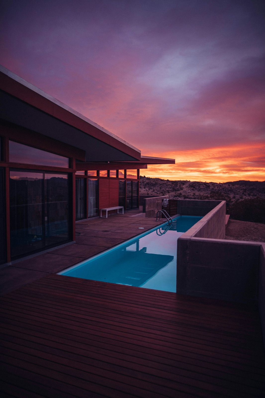 California pool builder reviewing design proposal with homeowner during a backyard consultation in a Los Angeles property